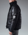 The Signature Huracan Men & Women's Black Puffer Jacket standing side image