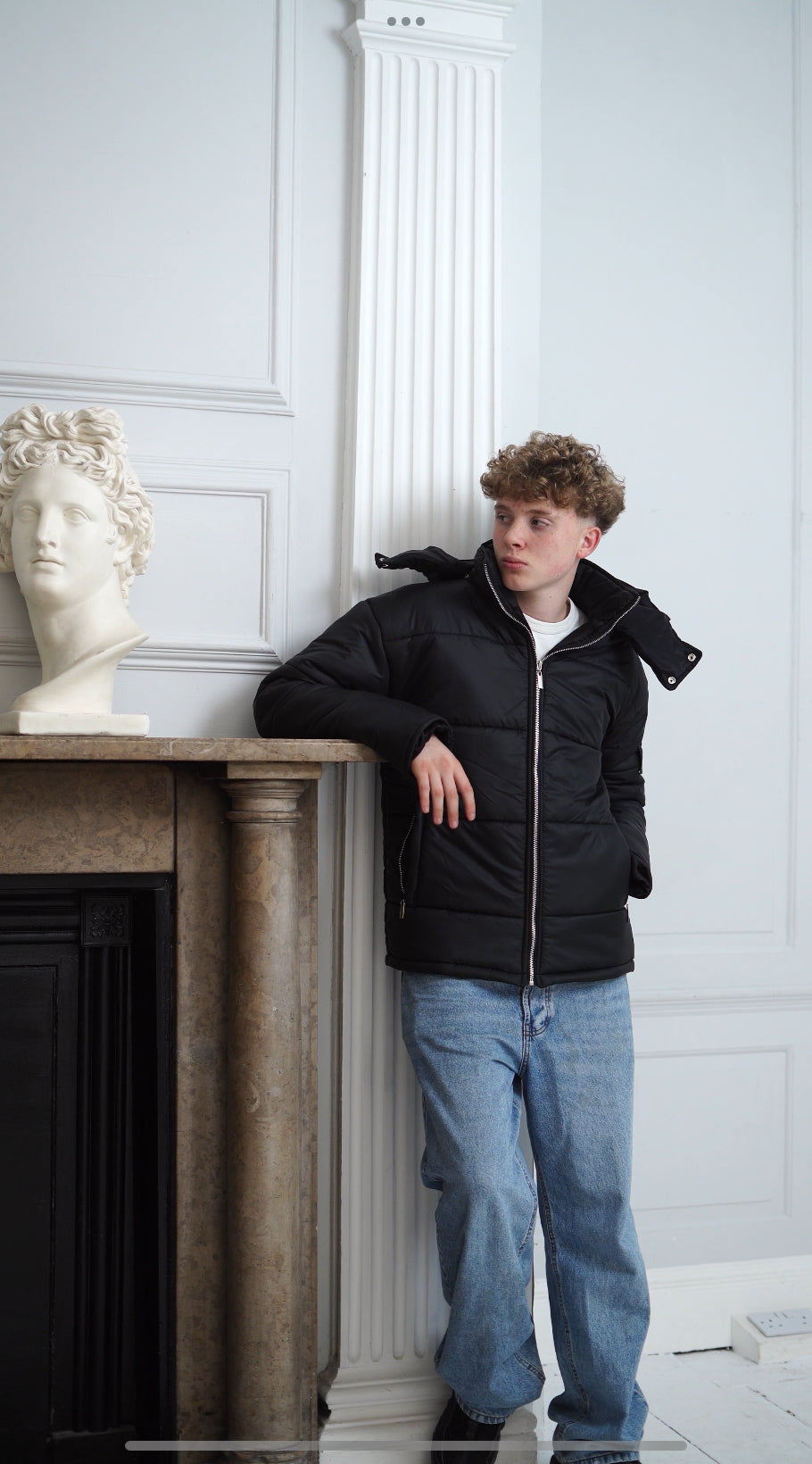 The Signature Huracan Men &amp; Women's Black Puffer Jacket hooded standing front mantle piece 