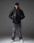 The Signature Huracan Men & Women's Black Puffer Jacket standing front pockets long shot