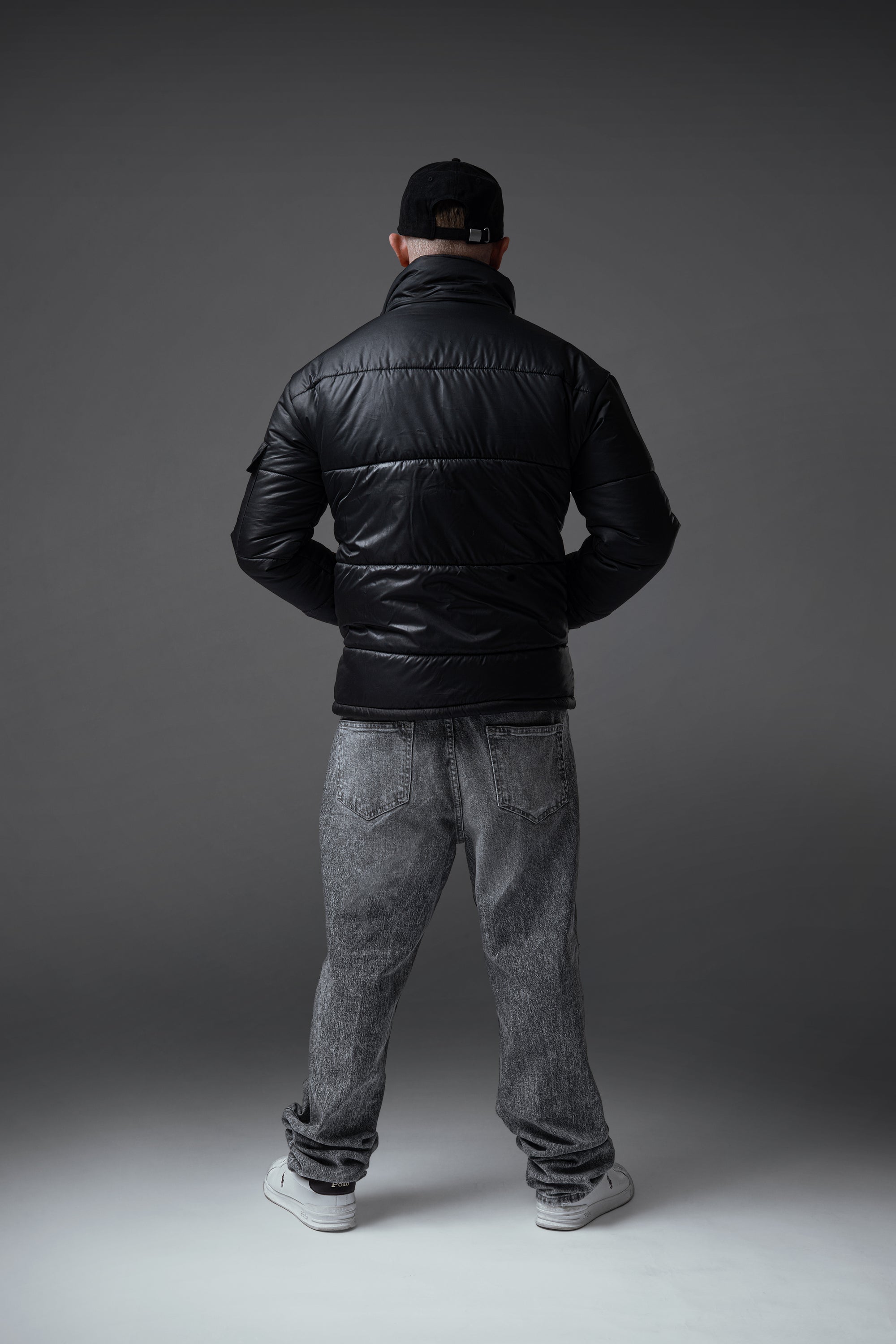 The Signature Huracan Men &amp; Women's Black Puffer Jacket standing back
