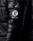 The Signature Huracan Men & Women's Black Puffer Jacket side arm close up