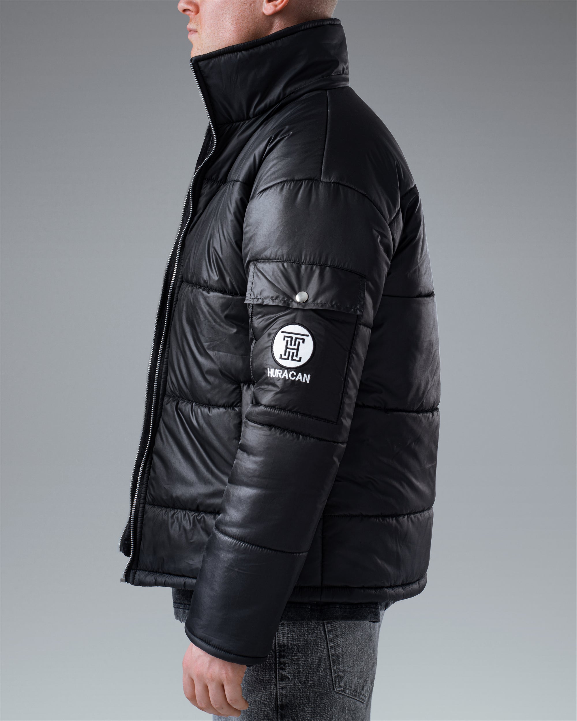 The Signature Huracan Men &amp; Women's Black Puffer Jacket standing side image