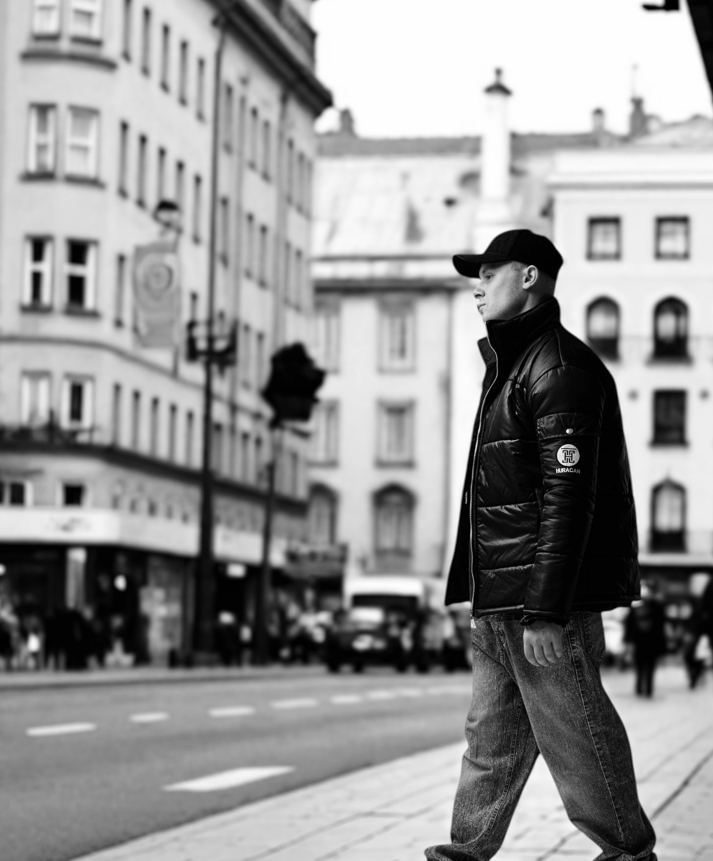 The Signature Huracan Men &amp; Women's Black Puffer Jacket walking side image